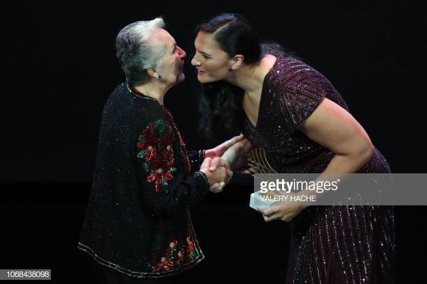 Puerto Rico's General Secretary of the Association of Pan-American Athletics Evelyn Claudio Lopez (L) receives the Woman of the year award from New Zealand's athlete Valerie Adams during the IAAF athlete of the year awards ceremony, on December 4, 2018 in Monaco. (Photo by Valery HACHE / AFP) (Photo credit should read VALERY HACHE/AFP/Getty Images)